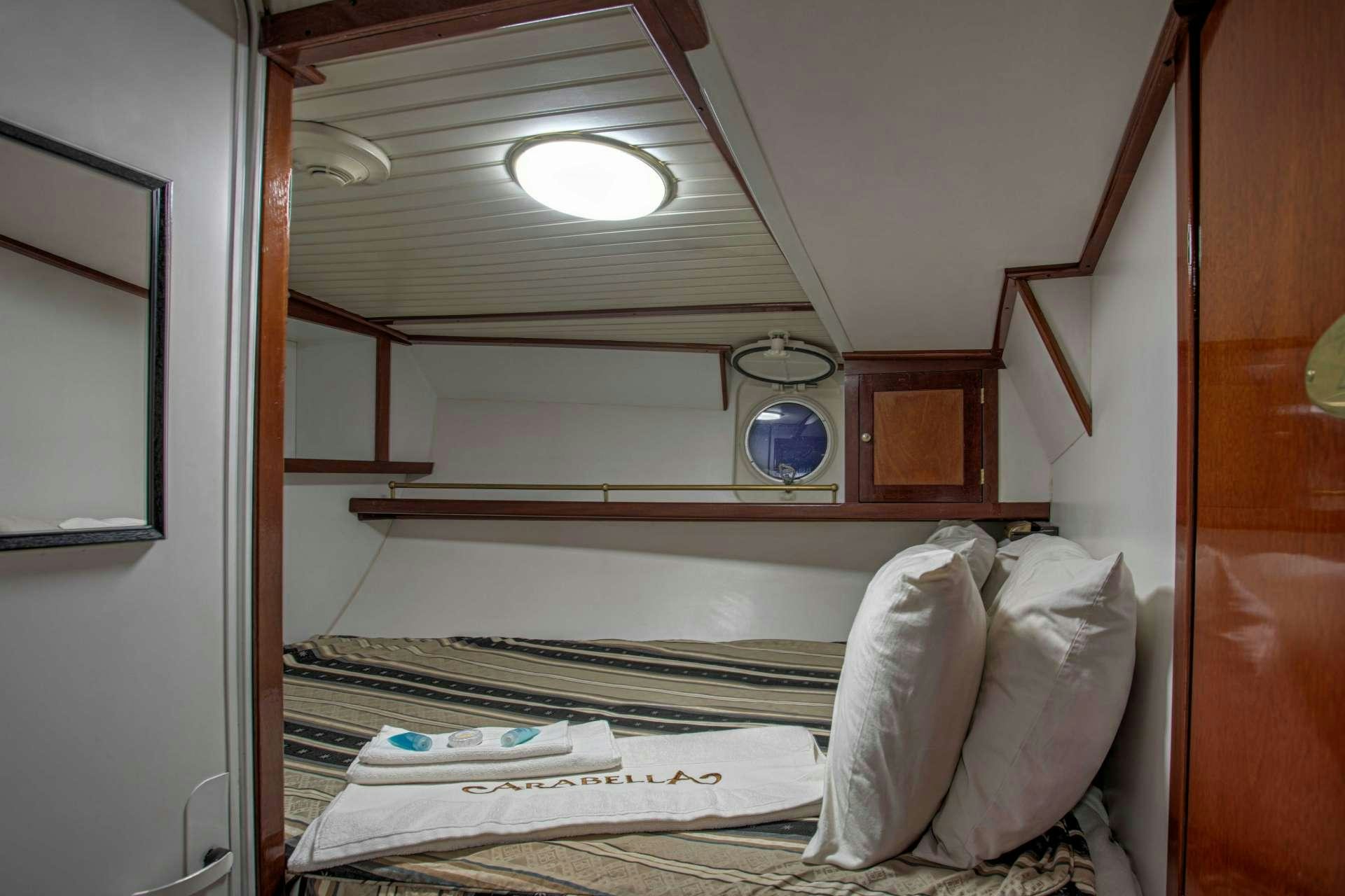 a bed with a mirror above it aboard ARABELLA II Yacht for Charter