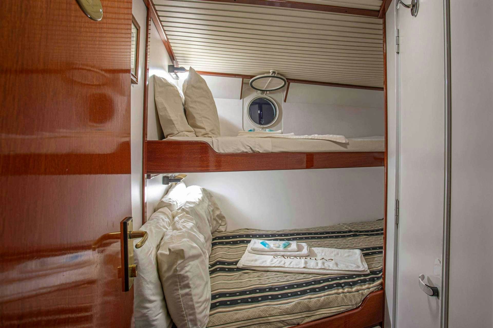 a bed with a mirror above it aboard ARABELLA II Yacht for Charter