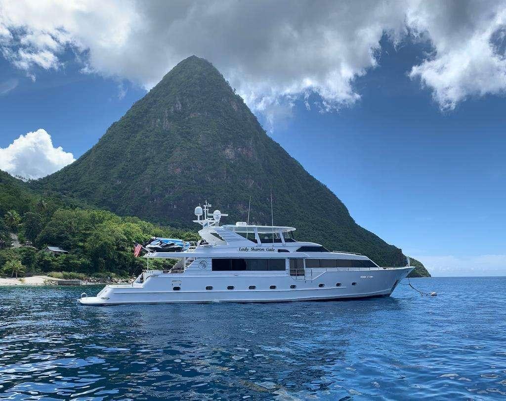 a boat in the water with Pitons in the background aboard DENISE ROSE Yacht for Charter