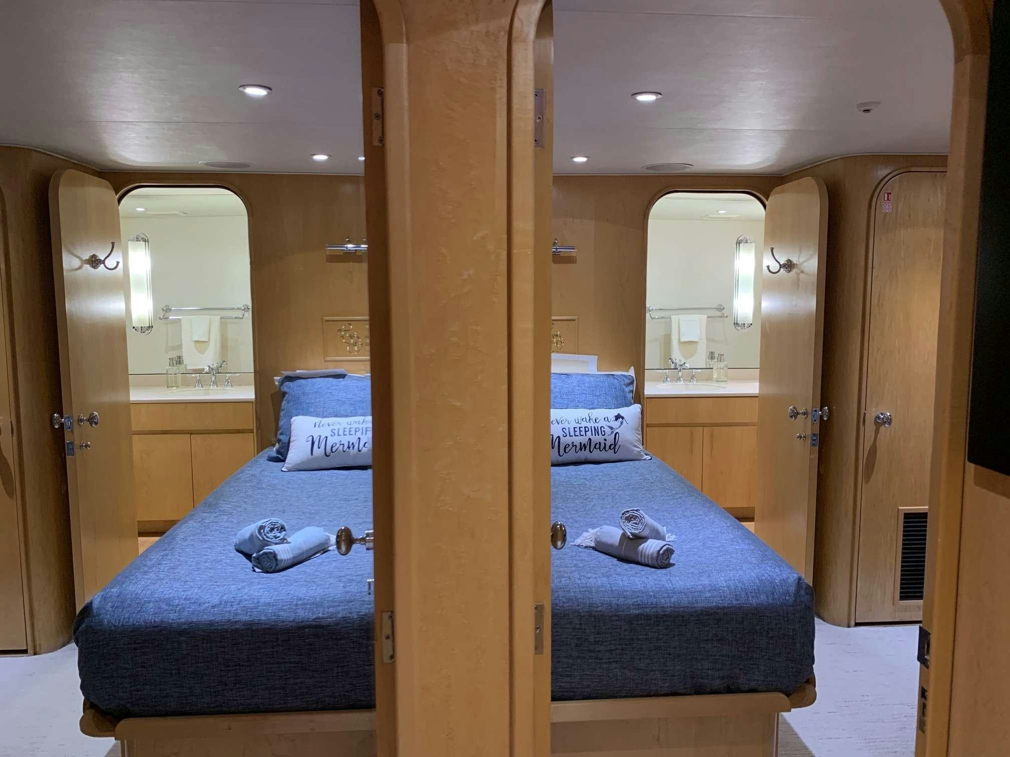 a bedroom with a large wood door aboard DENISE ROSE Yacht for Charter
