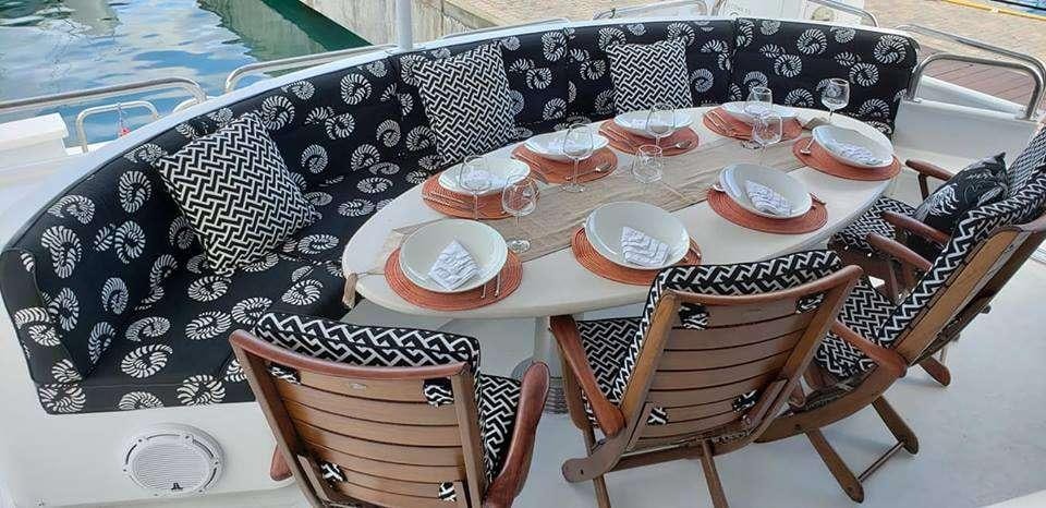 a table with plates and chairs aboard DENISE ROSE Yacht for Charter