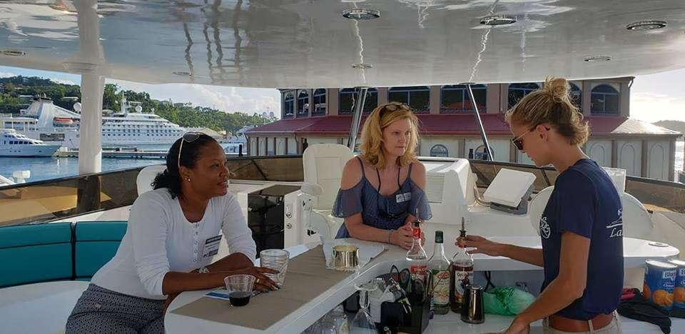a group of people sitting at a table aboard DENISE ROSE Yacht for Charter