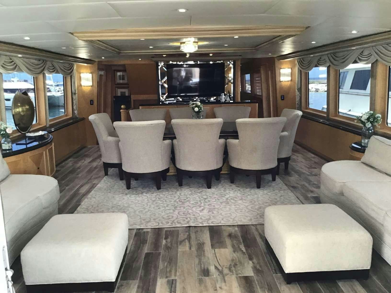 a large living room with a large sofa and a large television aboard DENISE ROSE Yacht for Charter