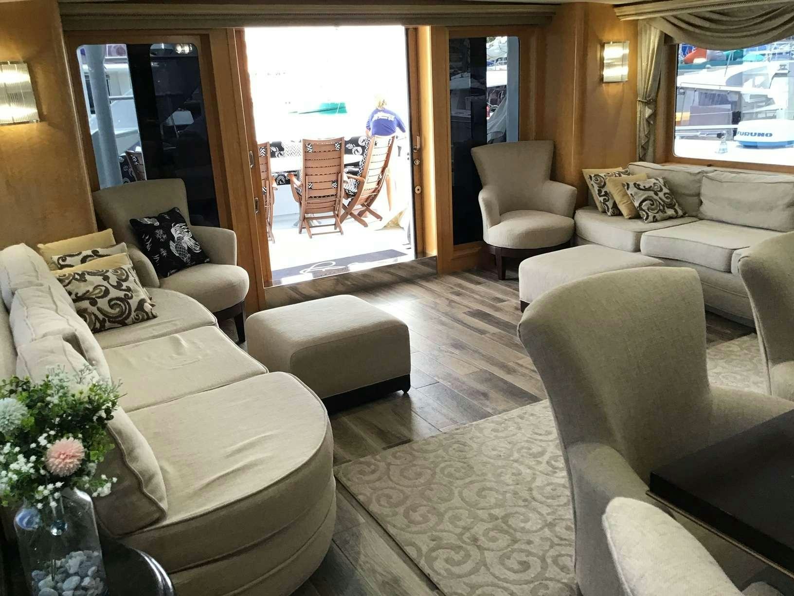 a living room with a large window aboard DENISE ROSE Yacht for Charter