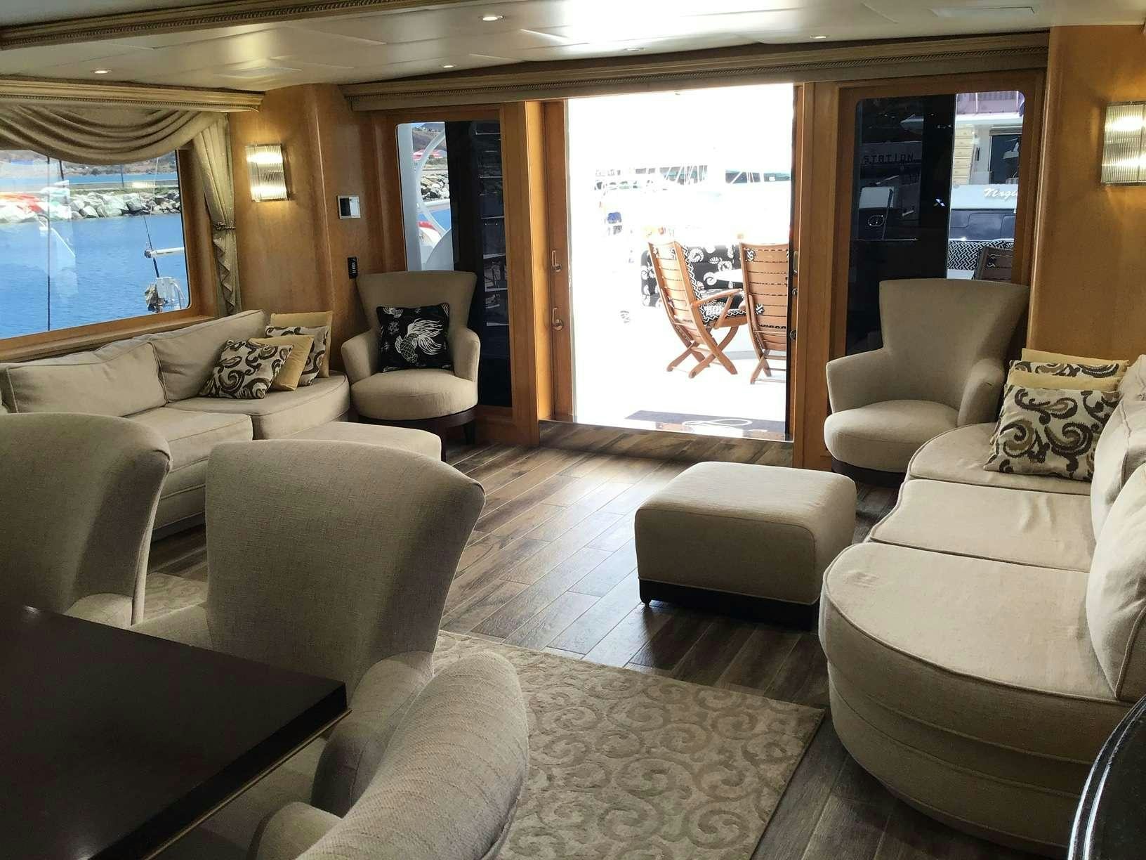 a living room with a large screen aboard DENISE ROSE Yacht for Charter