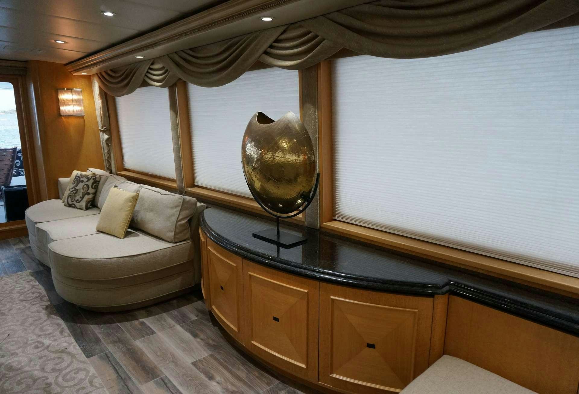 a room with a large mirror and a couch aboard DENISE ROSE Yacht for Charter