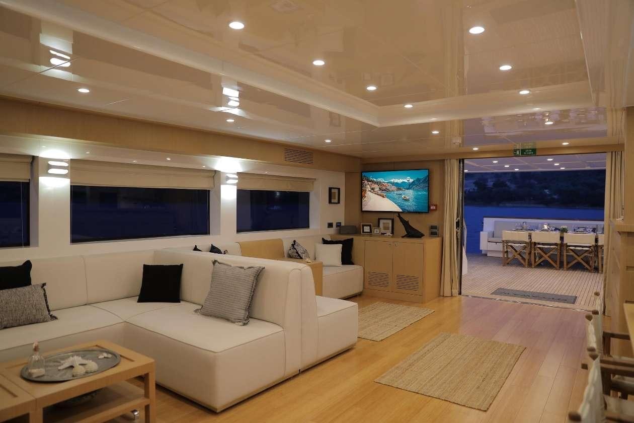 a living room with a large screen aboard OTTAWA IV Yacht for Charter