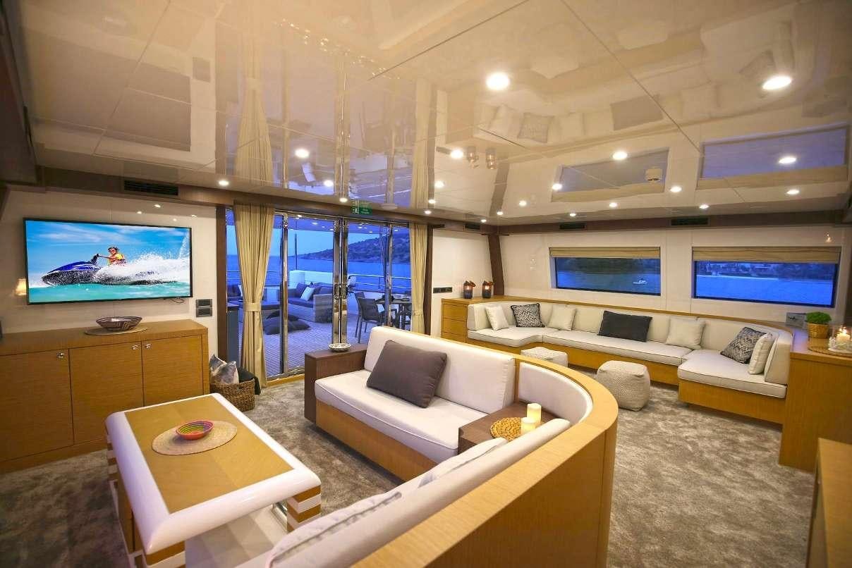 a living room with a large window aboard OTTAWA IV Yacht for Charter