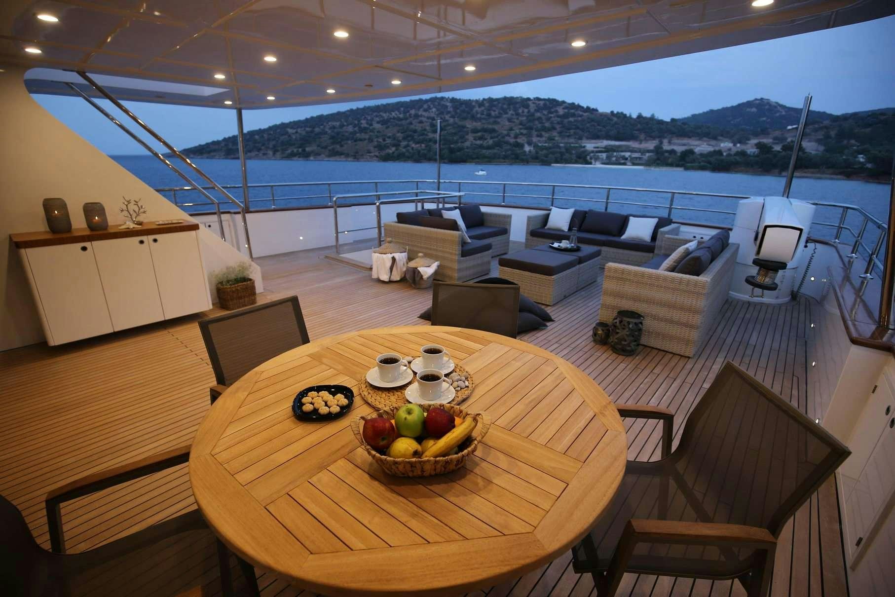 a table with chairs and a couch aboard OTTAWA IV Yacht for Charter