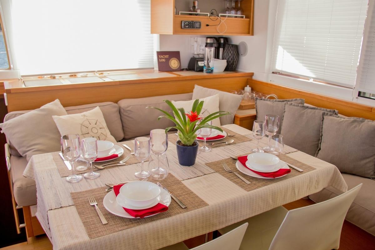 a table with plates and glasses on it aboard COOL RUNNINGS IV Yacht for Charter