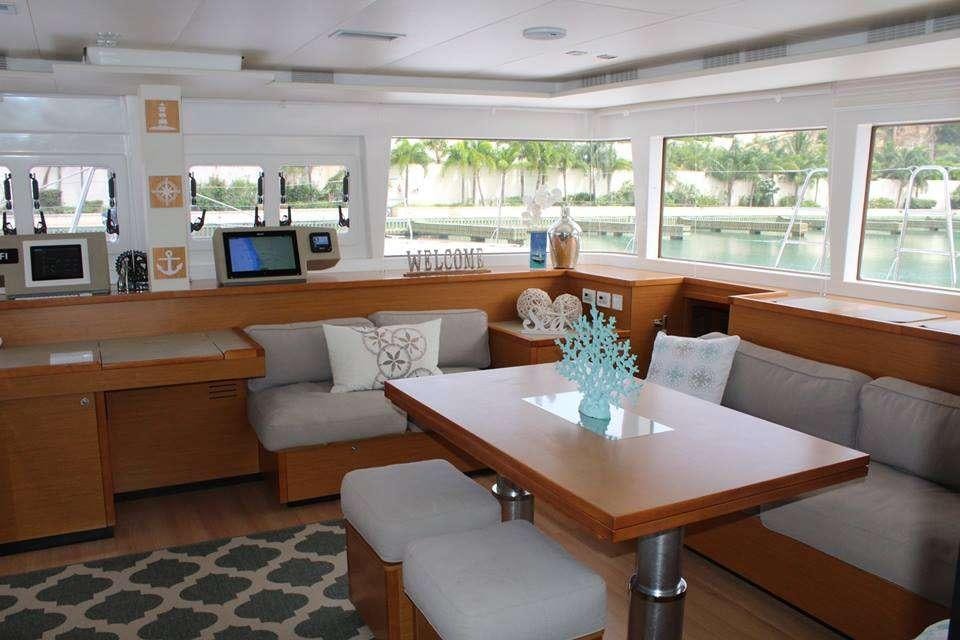a living room with a table and couches aboard COOL RUNNINGS IV Yacht for Charter