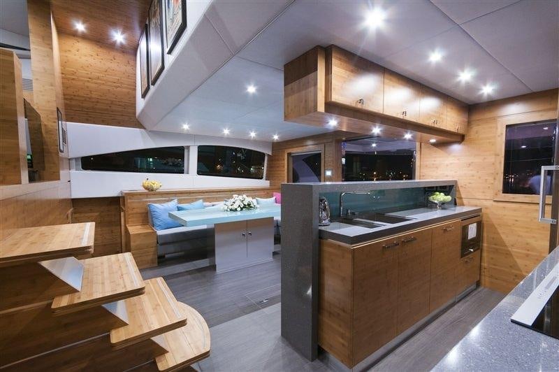 a modern kitchen with wooden cabinets aboard SKYLARK Yacht for Charter