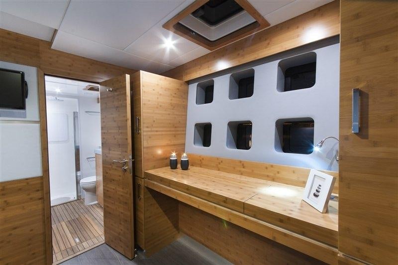 a room with a wood floor and a tv on the wall aboard SKYLARK Yacht for Charter
