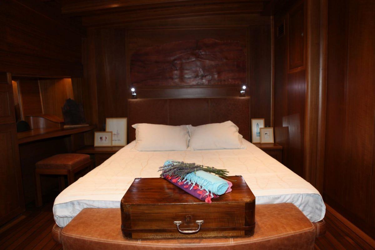 a bed with a pillow on it aboard CAKIRYILDIZ Yacht for Charter