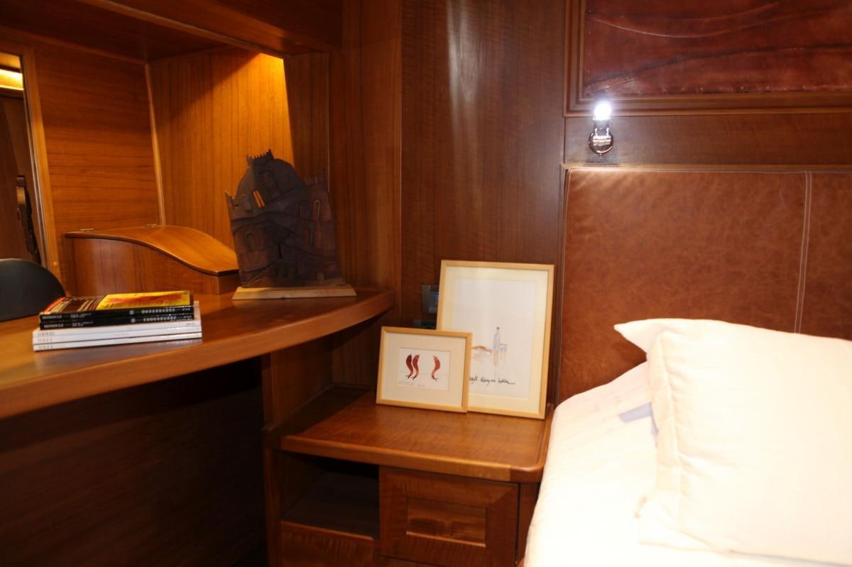 a room with a desk and a bed aboard CAKIRYILDIZ Yacht for Charter