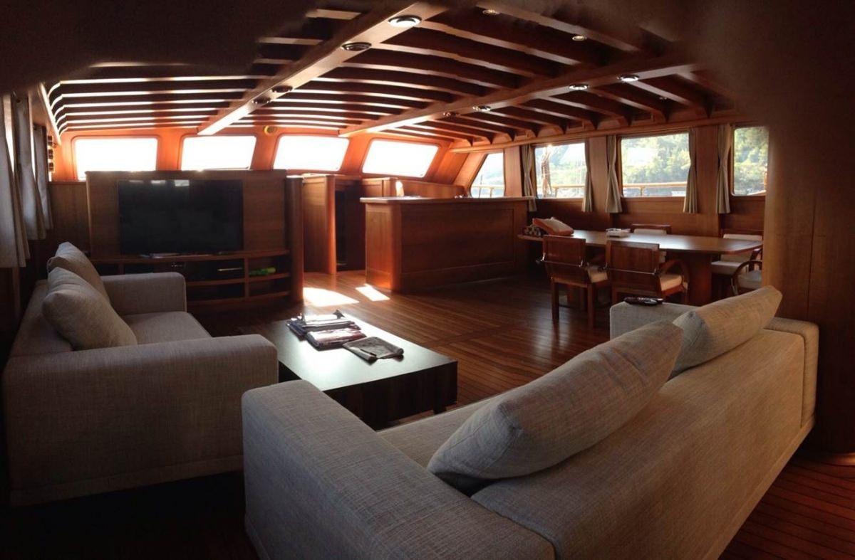 a living room with a couch and a tv aboard CAKIRYILDIZ Yacht for Charter