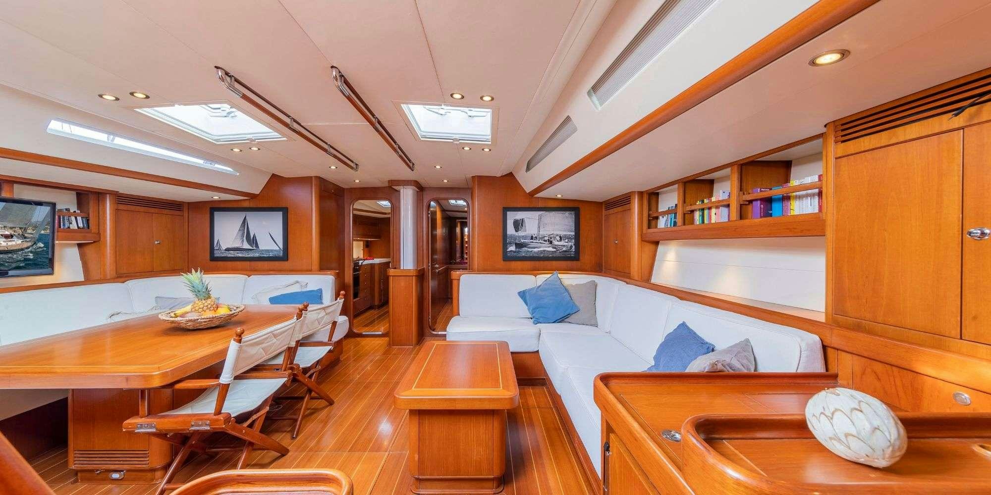 a room with a couch and a television aboard ELISE WHISPER Yacht for Charter