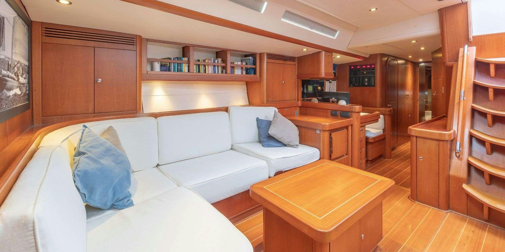 a living room with a couch and a table aboard ELISE WHISPER Yacht for Charter