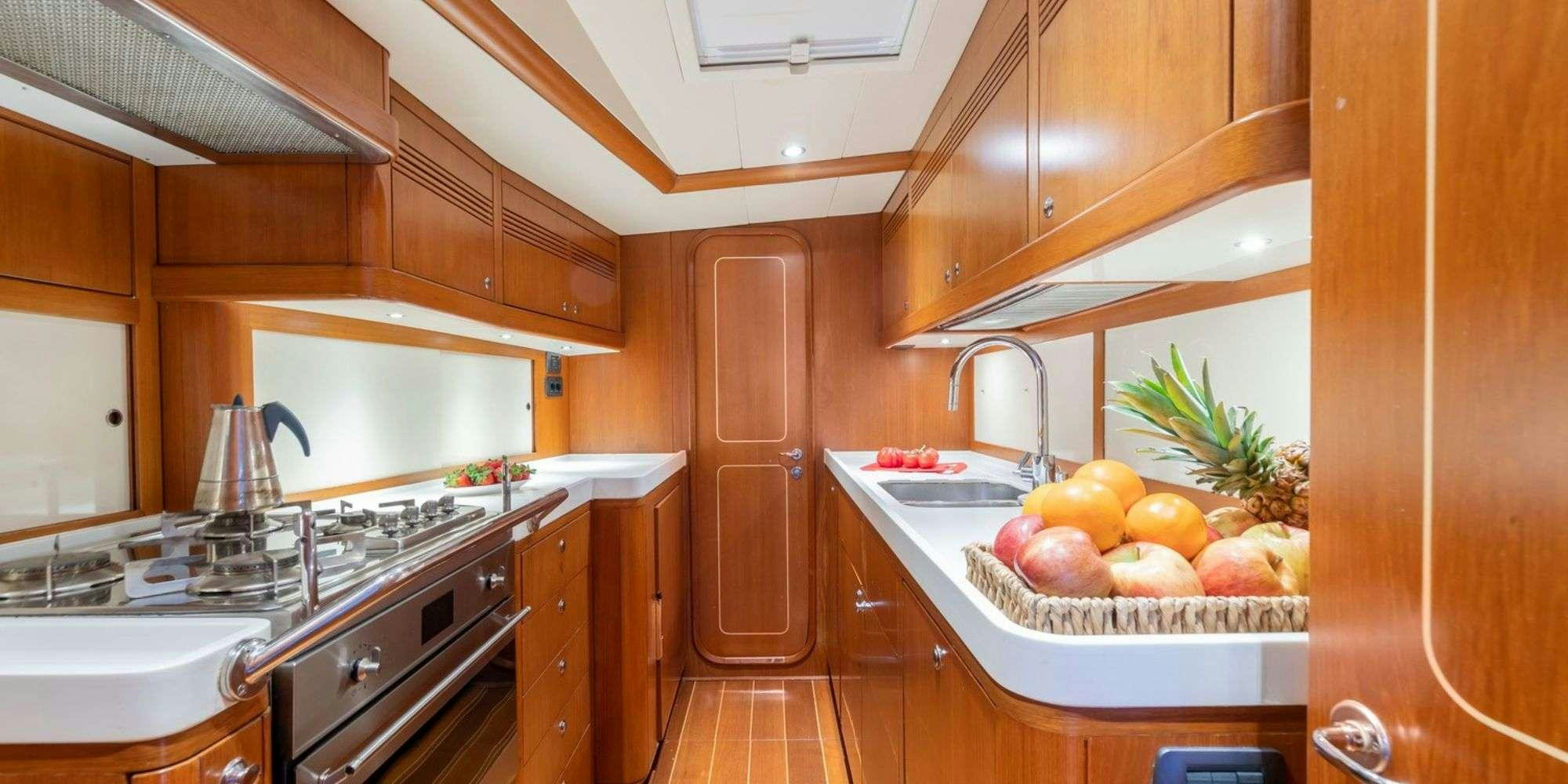a kitchen with wooden cabinets aboard ELISE WHISPER Yacht for Charter