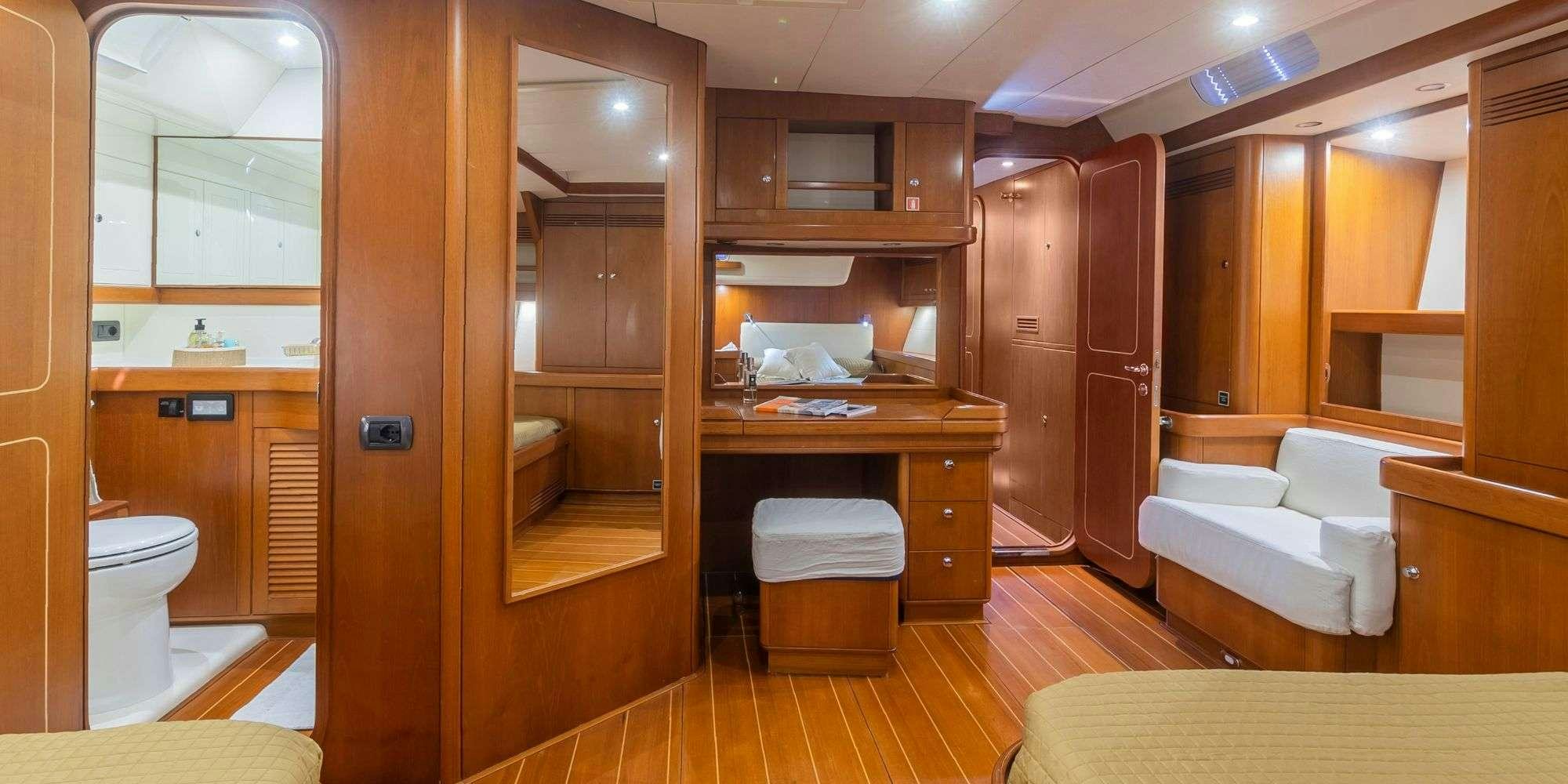a room with a bed and a closet aboard ELISE WHISPER Yacht for Charter
