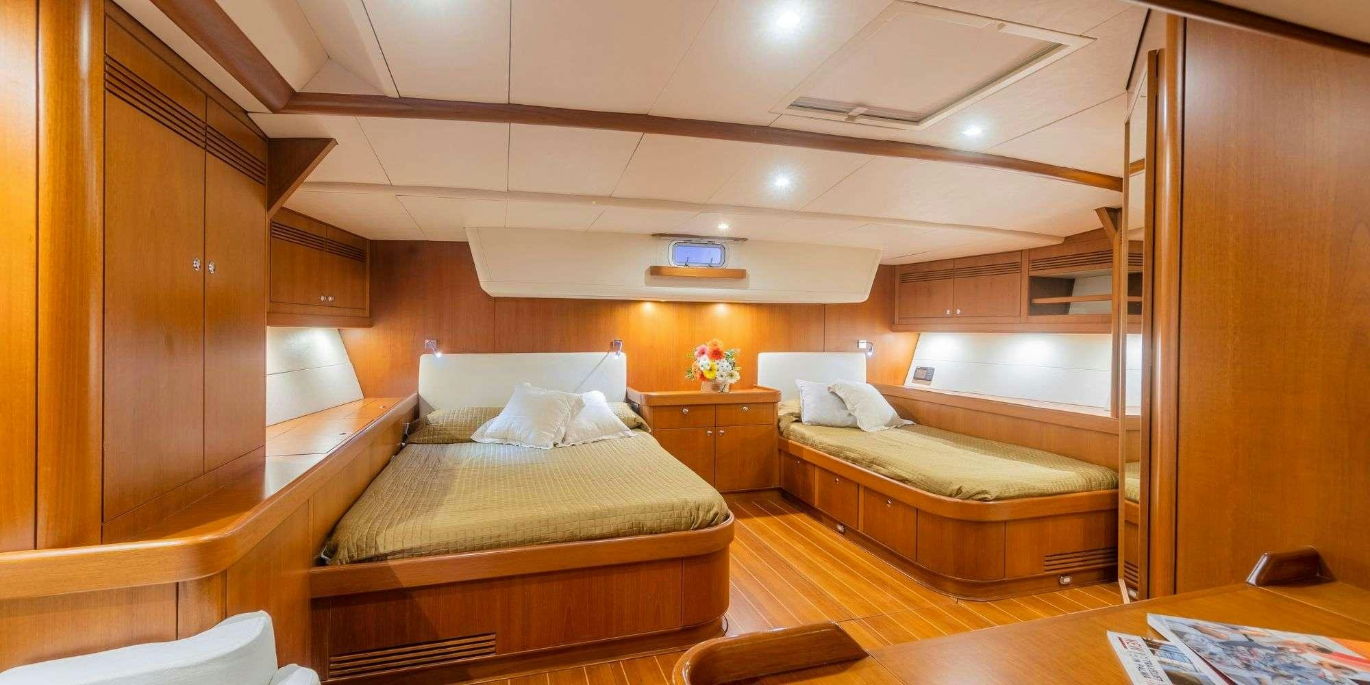 a room with a couple of beds aboard ELISE WHISPER Yacht for Charter