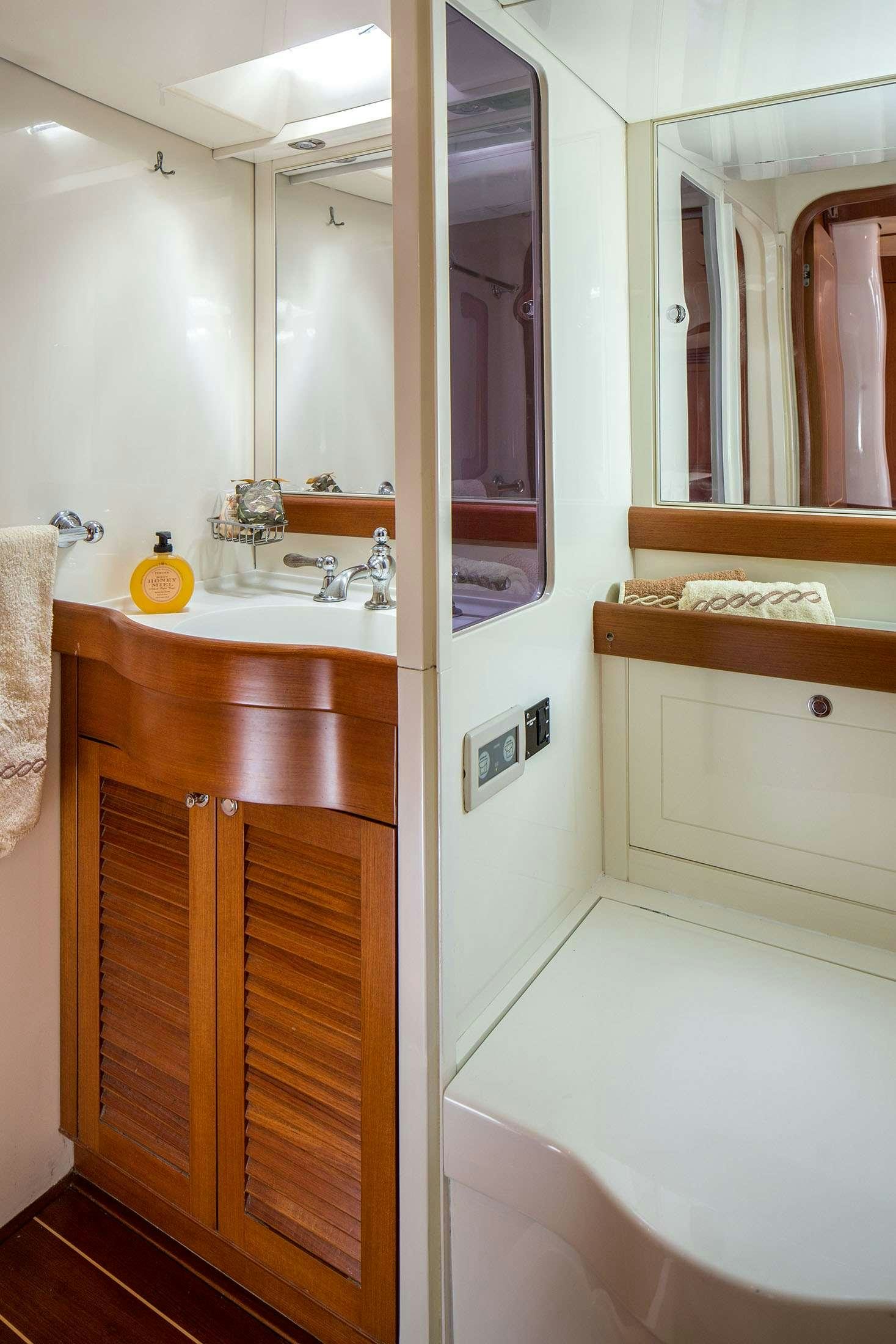 a bathroom with a sink and a mirror aboard ELISE WHISPER Yacht for Charter