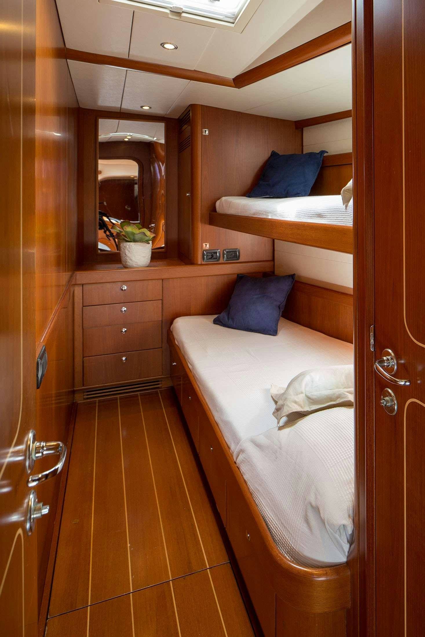 a room with a bed and a mirror aboard ELISE WHISPER Yacht for Charter