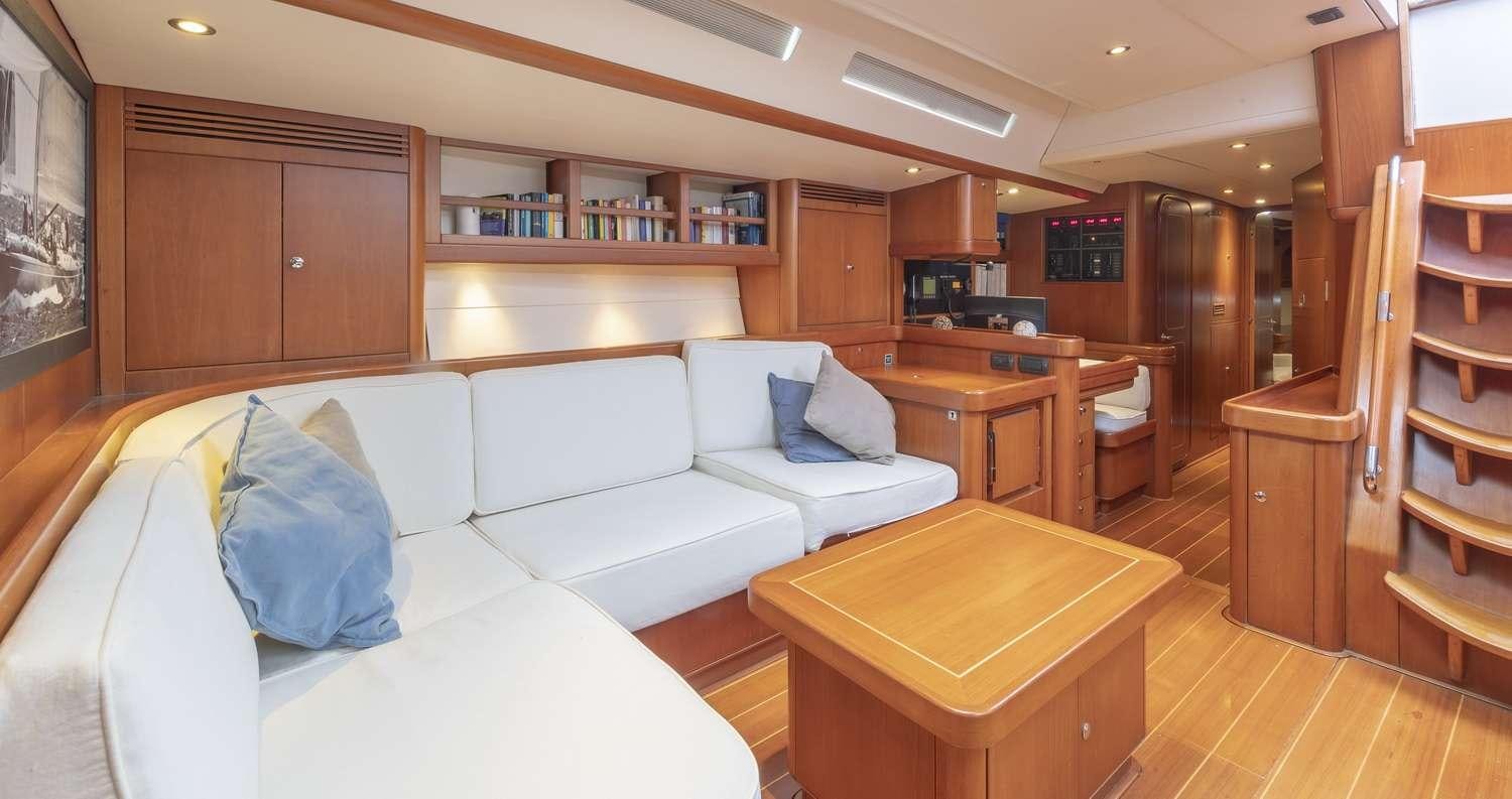 a living room with a couch and a table aboard ELISE WHISPER Yacht for Charter