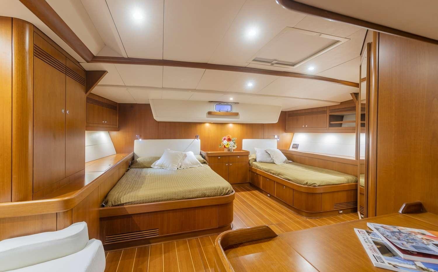 a room with a bed and a desk aboard ELISE WHISPER Yacht for Charter