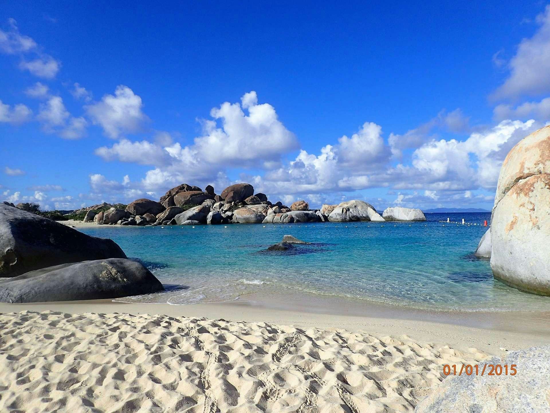 a beach with rocks and water aboard ELIXIR Yacht for Charter