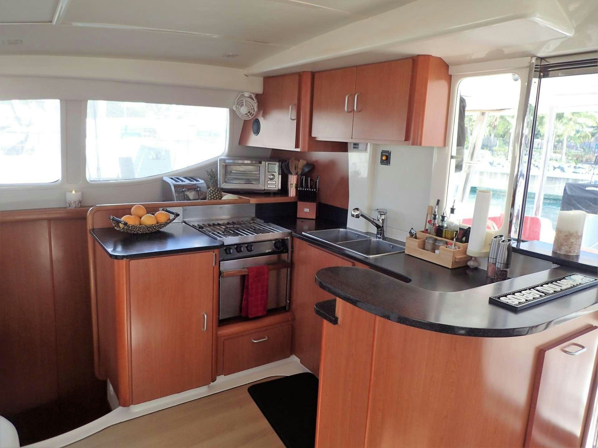 a kitchen with wooden cabinets aboard ELIXIR Yacht for Charter