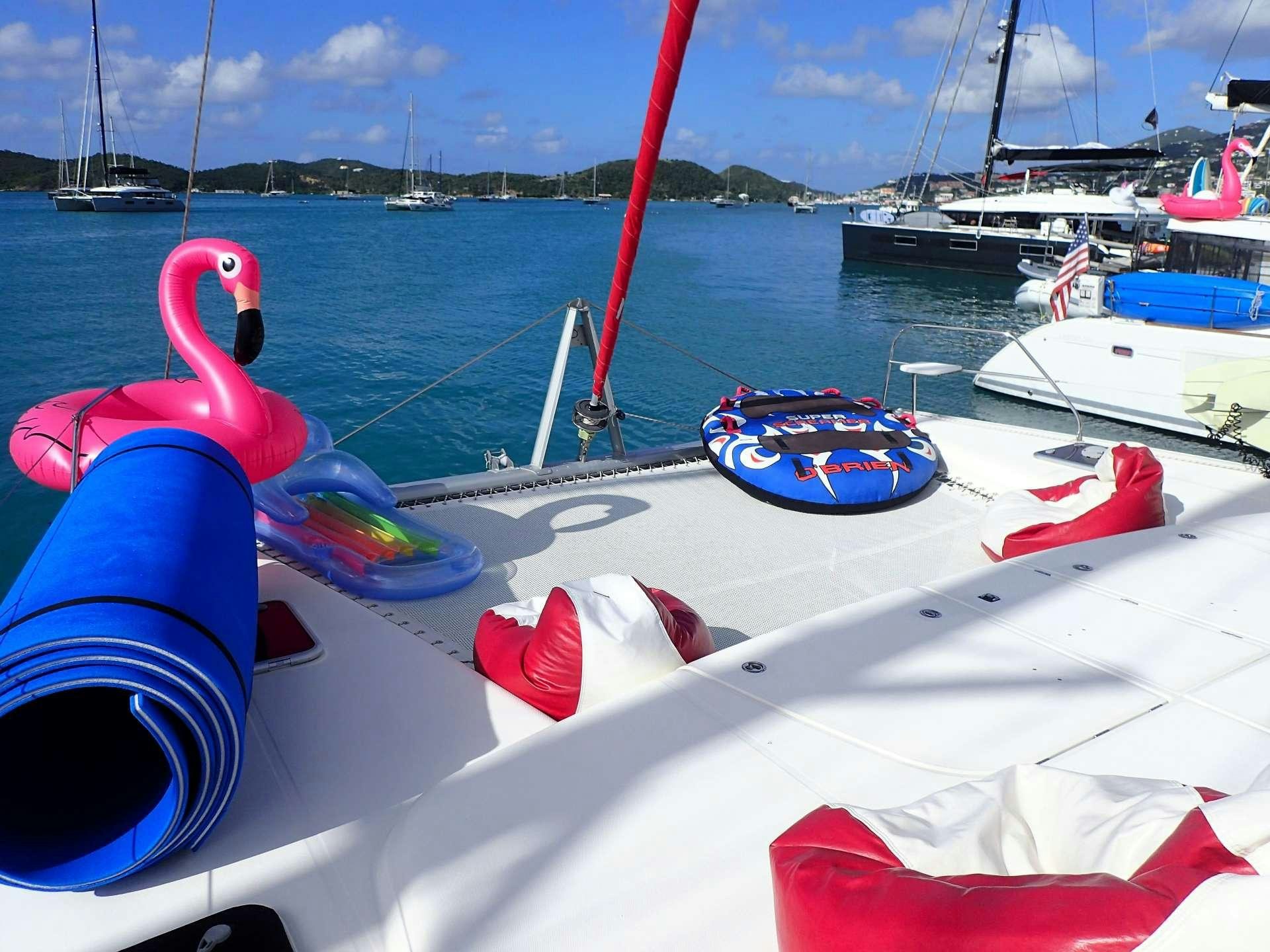 a boat with a red and white sail and a blue and white boat in the water aboard ELIXIR Yacht for Charter