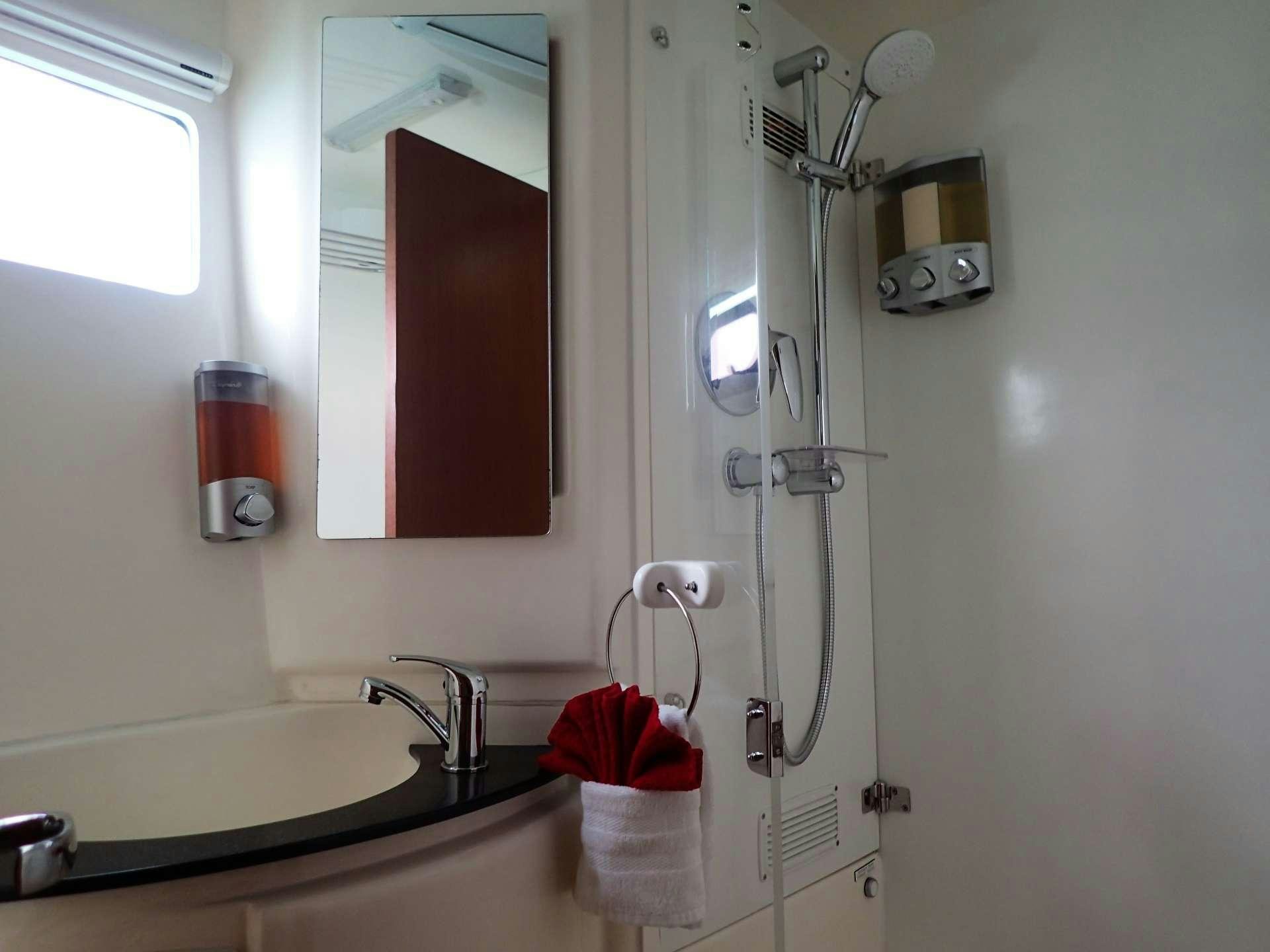 a bathroom with a sink and mirror aboard ELIXIR Yacht for Charter