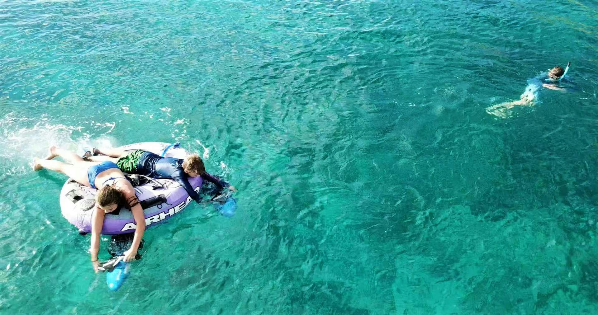 a couple of people swimming in the ocean aboard SERENITY NOW Yacht for Charter