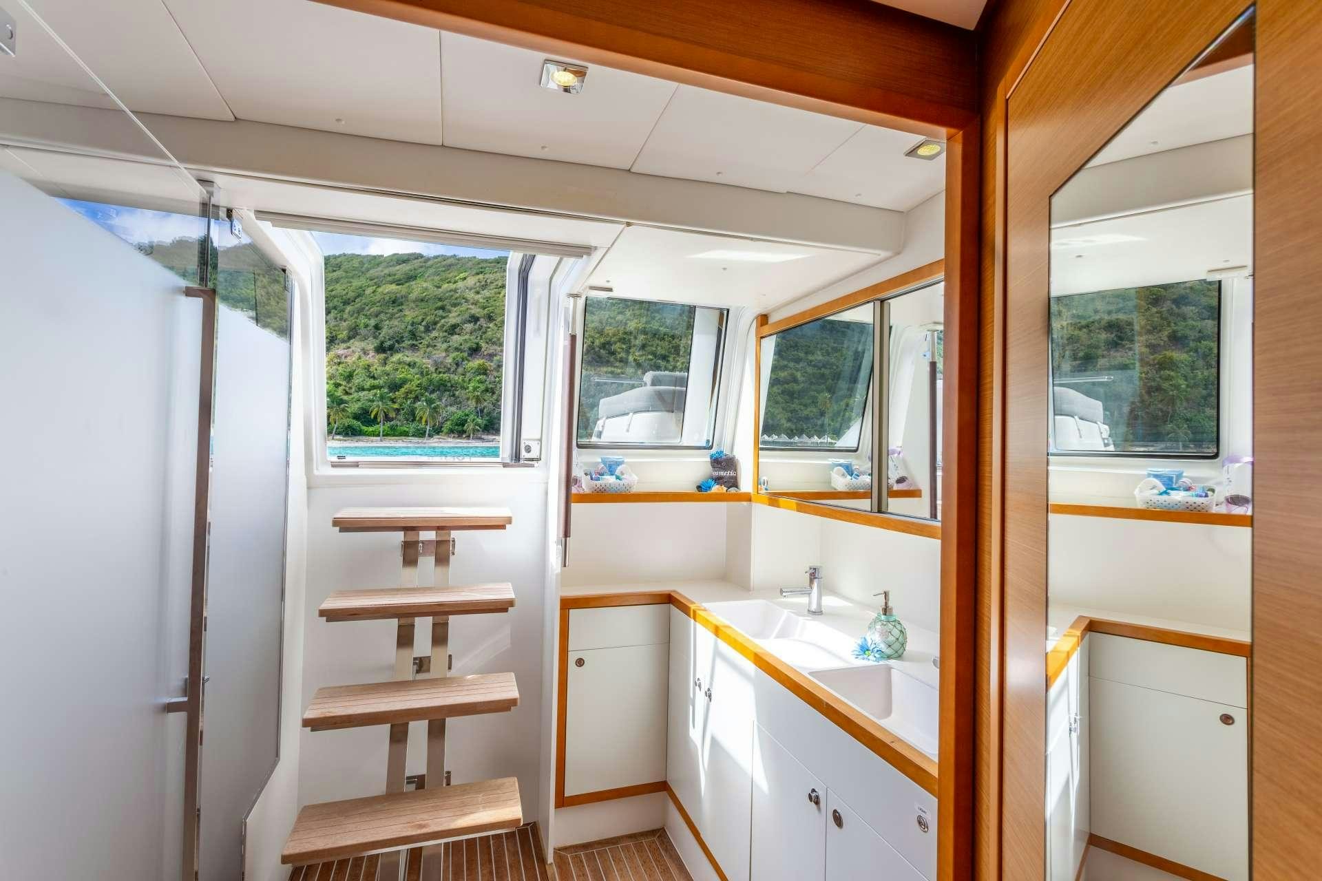 a room with a sink and a window aboard SERENITY NOW Yacht for Charter