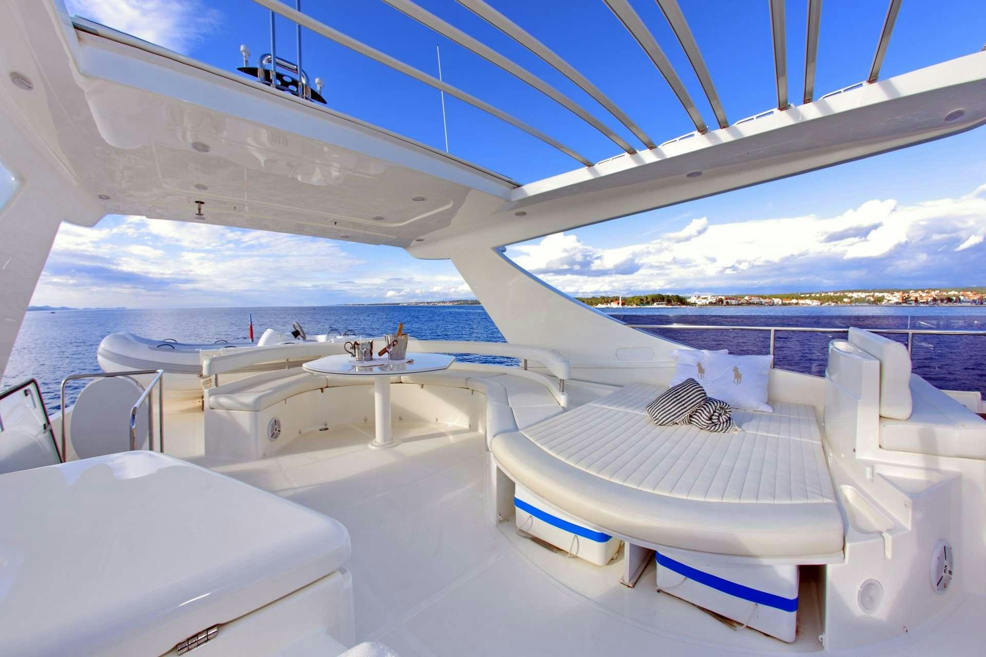 a room with white beds aboard TESORO Yacht for Charter