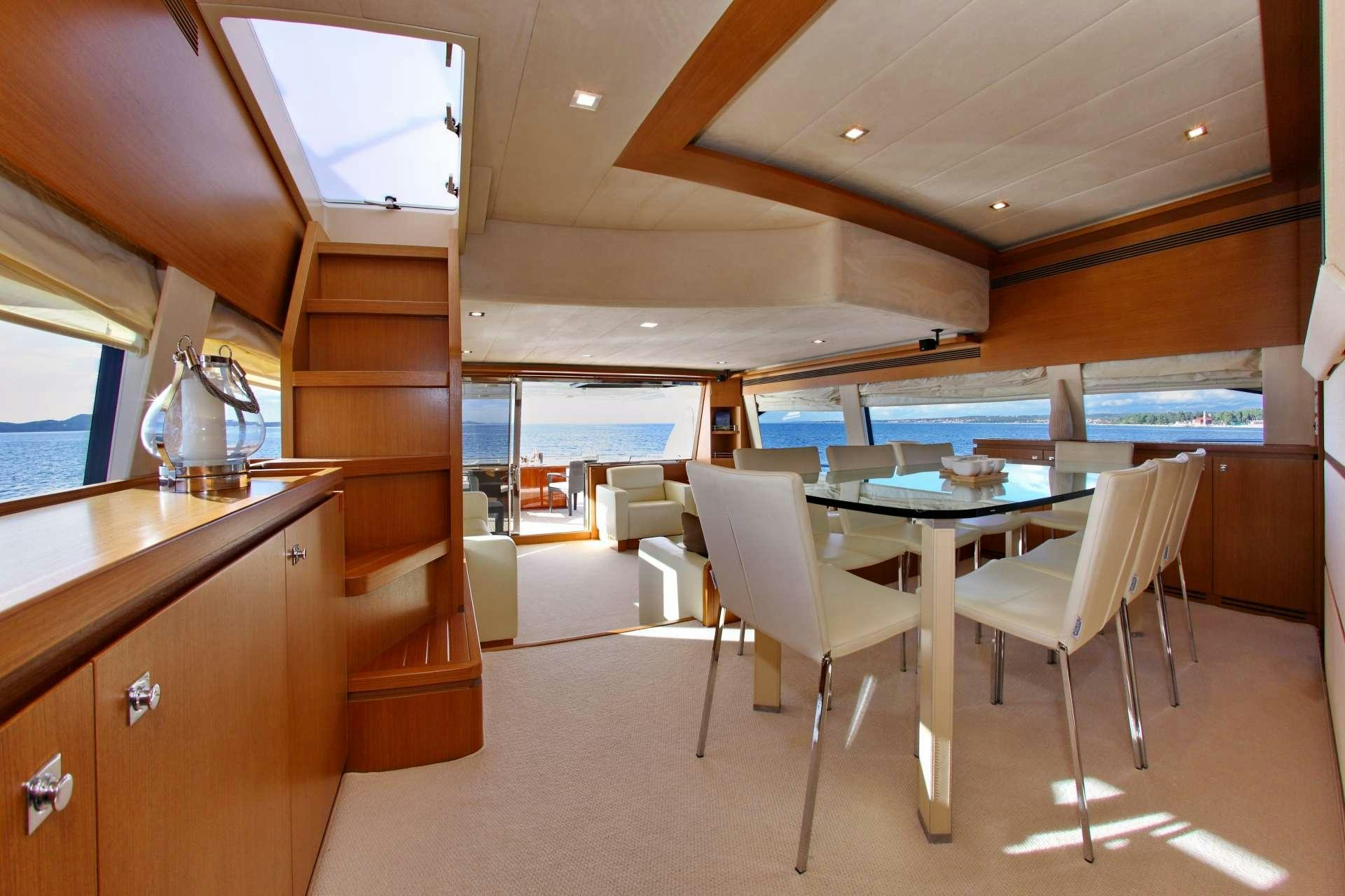 a room with a table and chairs aboard TESORO Yacht for Charter