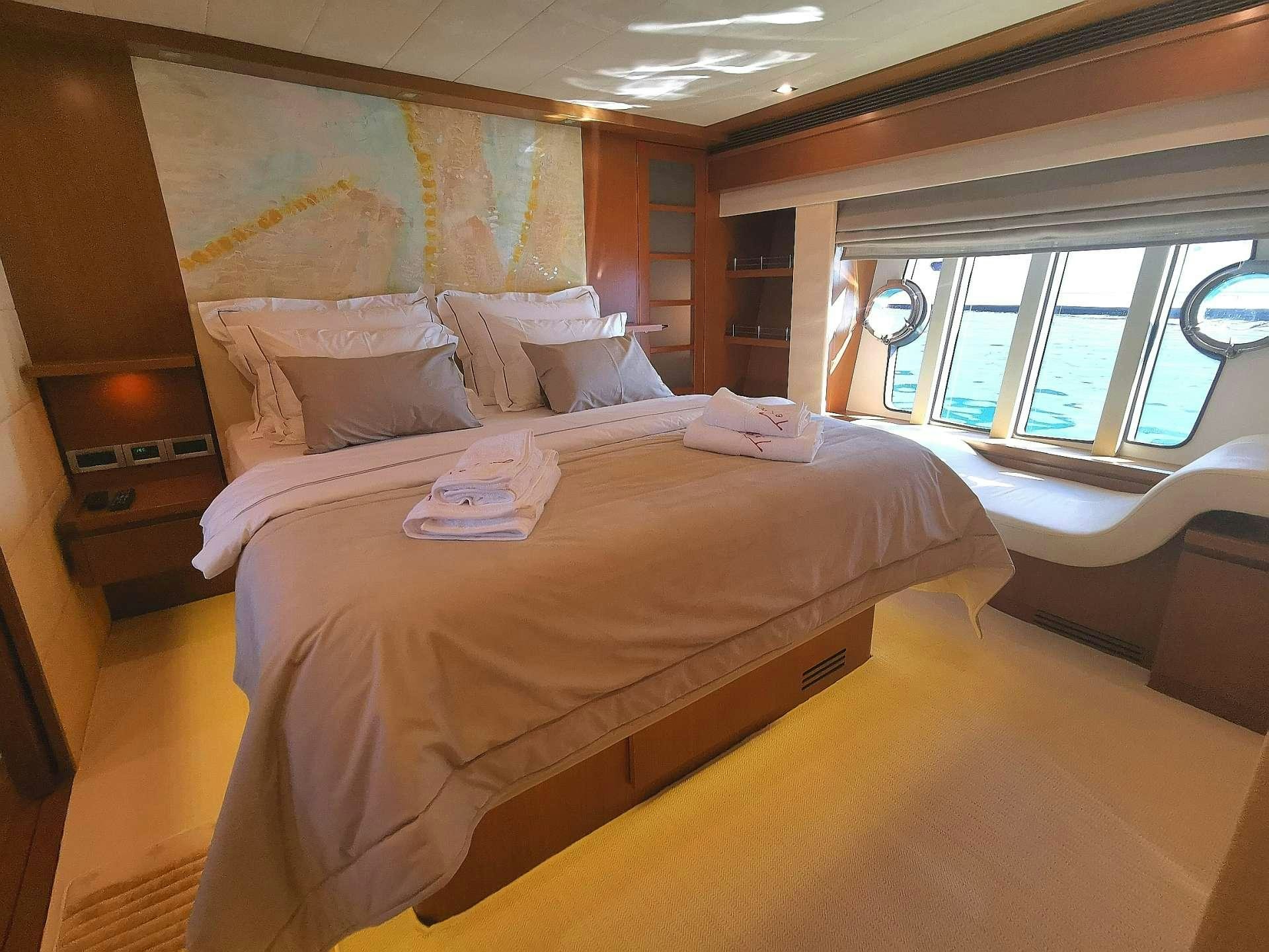 a bed with a tray on it aboard TESORO Yacht for Charter