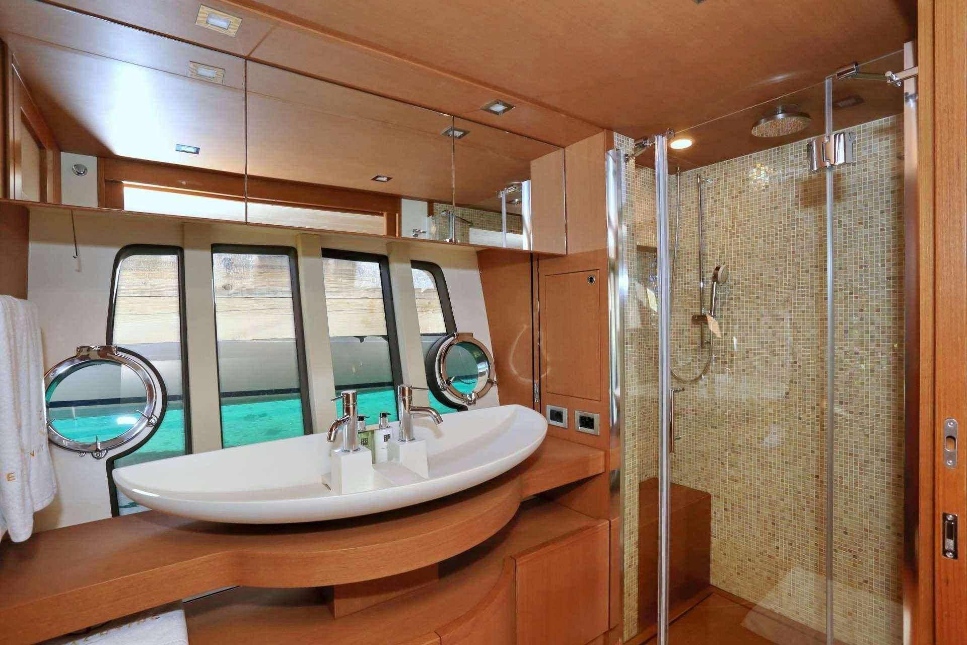 a bathroom with a sink and a shower aboard TESORO Yacht for Charter