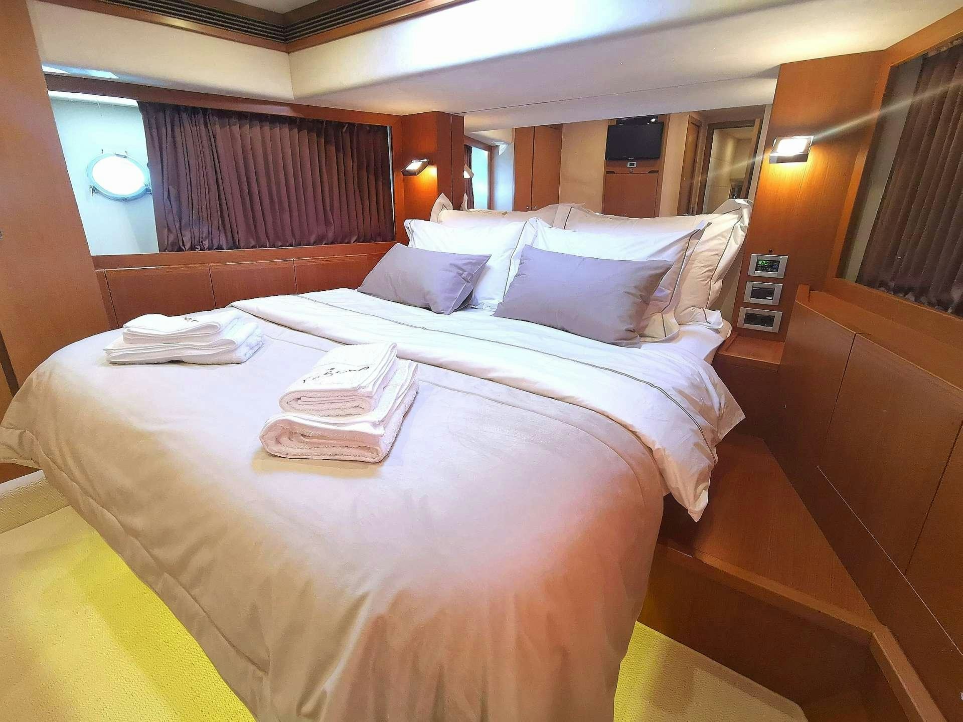 a room with a bed and a desk aboard TESORO Yacht for Charter