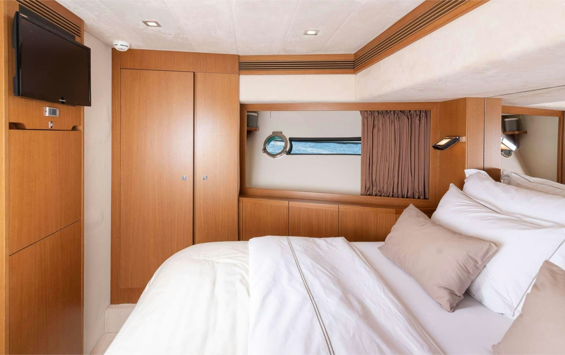 a bed with white sheets aboard TESORO Yacht for Charter