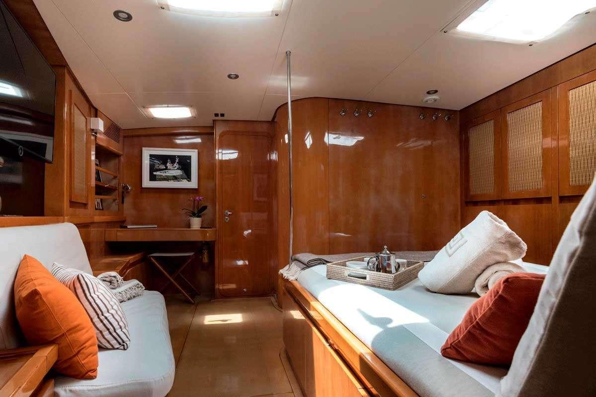 a room with a bed and a desk aboard LOGICA/QUINTA SANTA MARIA Yacht for Charter
