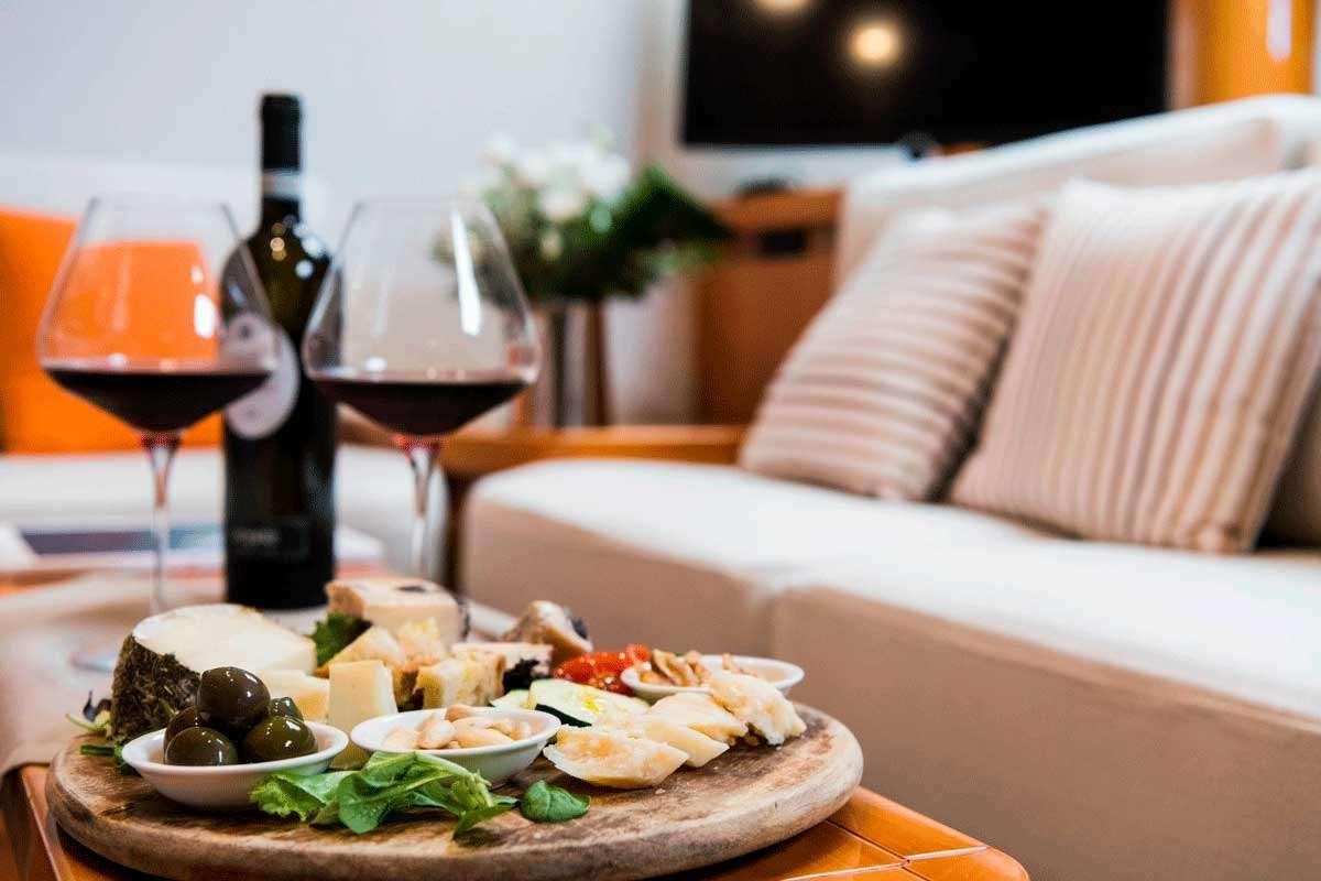 a table with food and wine aboard LOGICA/QUINTA SANTA MARIA Yacht for Charter