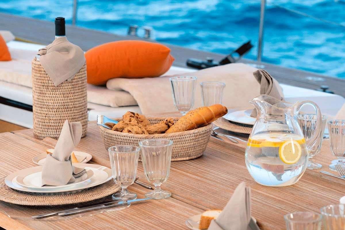 a table with food and drinks on it aboard LOGICA/QUINTA SANTA MARIA Yacht for Charter