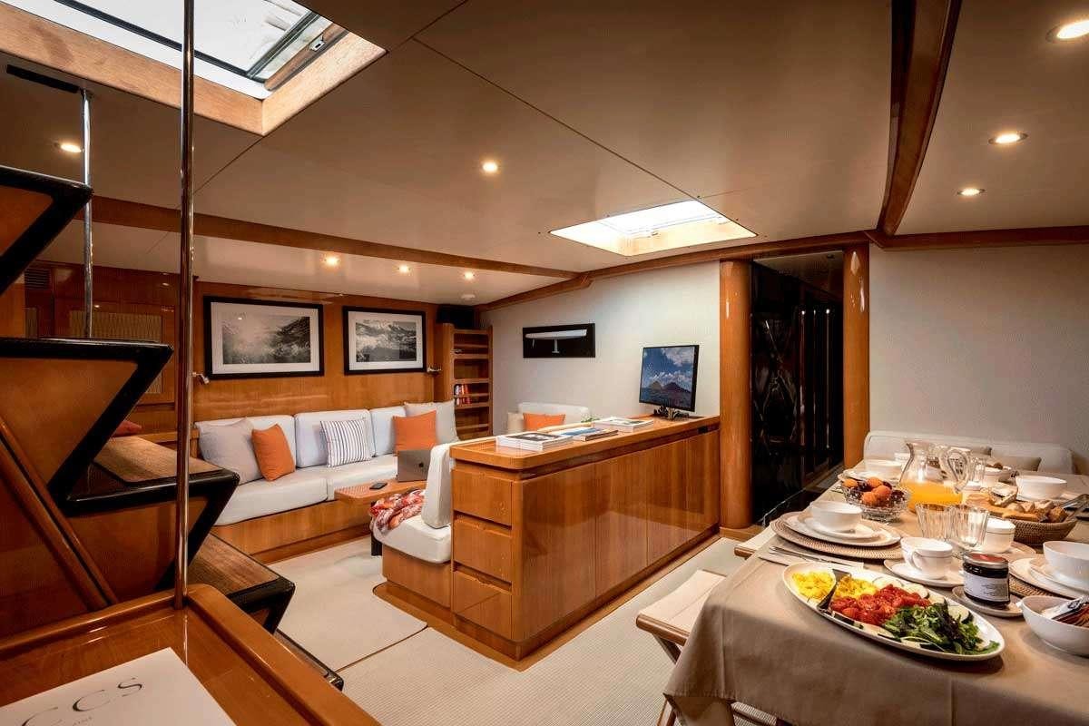 a room with a table and couches aboard LOGICA/QUINTA SANTA MARIA Yacht for Charter