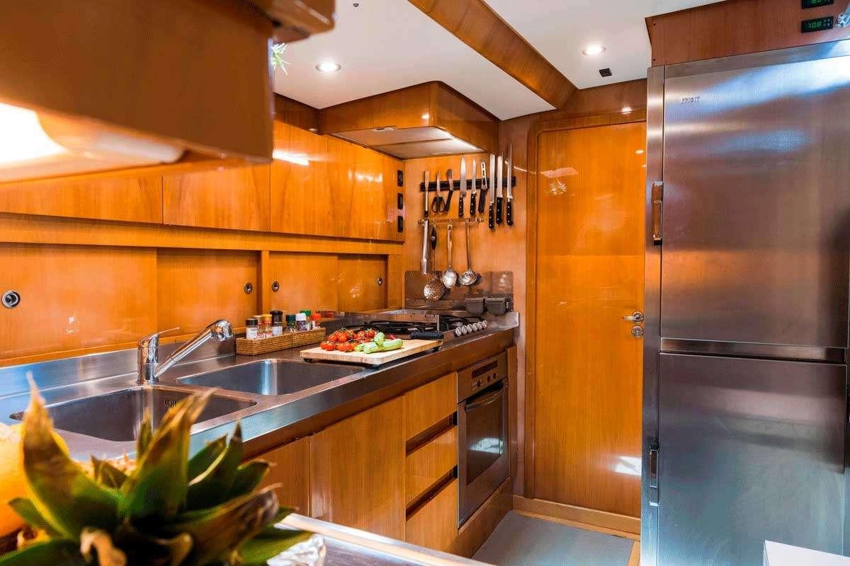 a kitchen with a stainless steel refrigerator aboard LOGICA/QUINTA SANTA MARIA Yacht for Charter