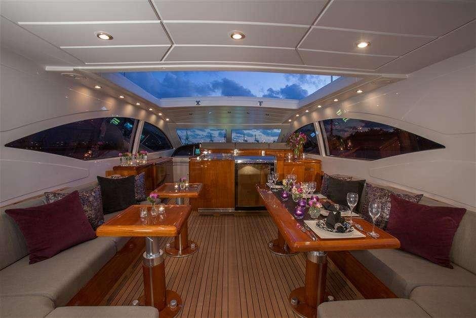 inside of a room with a large window and a table with chairs and a large window with a aboard YCM Yacht for Charter