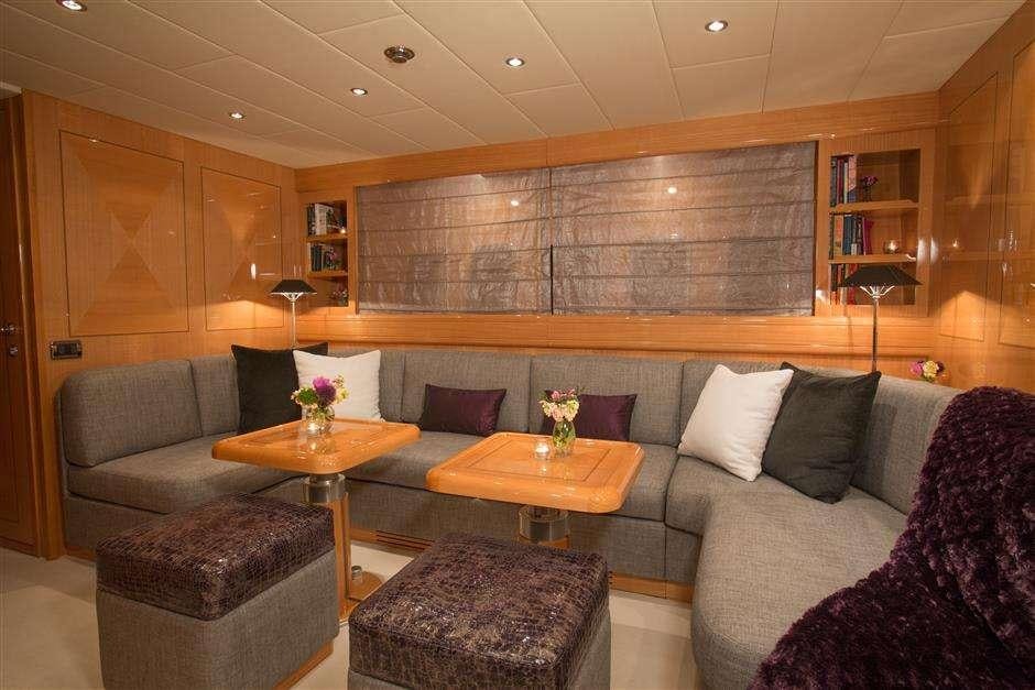 a living room with a couch and a coffee table aboard YCM Yacht for Charter