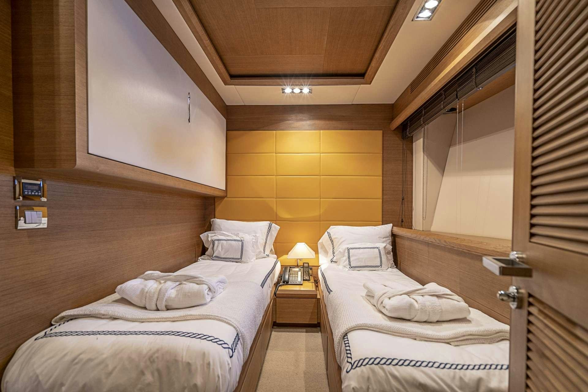 a room with two beds aboard INTERVENTION Yacht for Charter