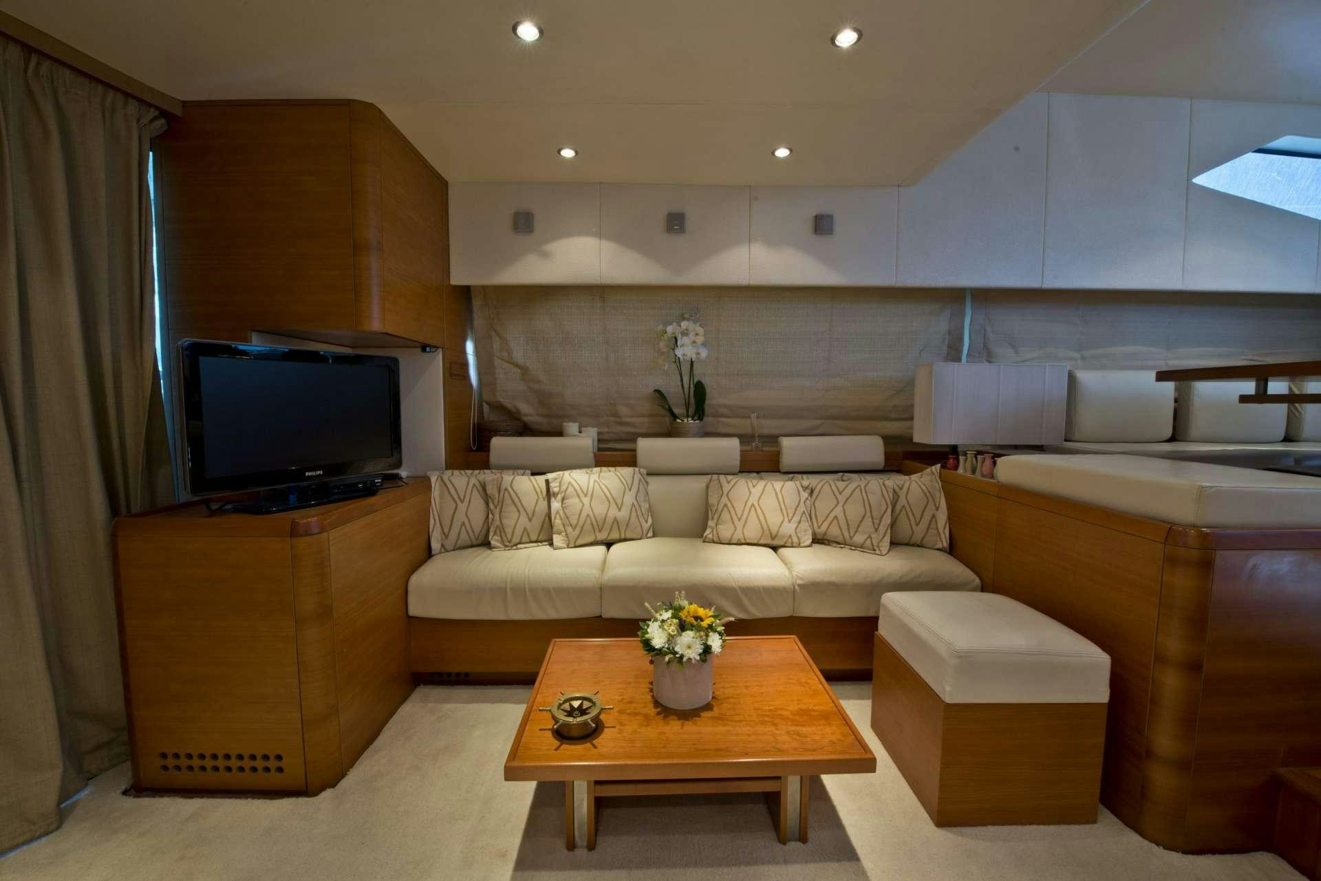 a living room with a couch and a television aboard JULY Yacht for Charter